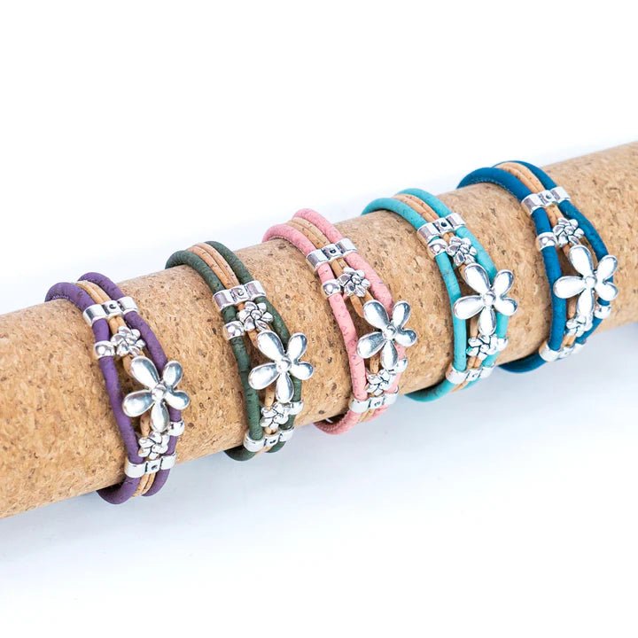 Set of colorful bracelets with 70s flower charms on a cork roll