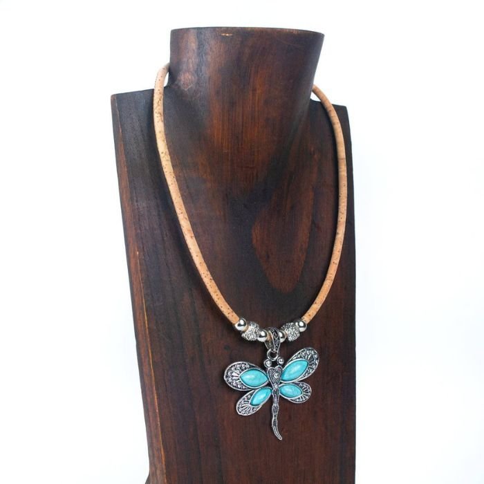 Cork necklace with a dragonfly pendant on a wooden stand display