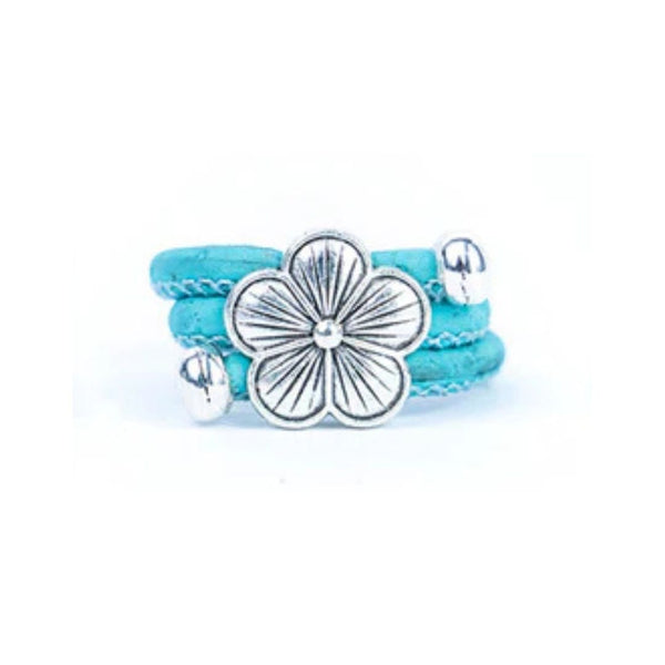Light Blue cork ring with a silver vintage floral charm on a white background