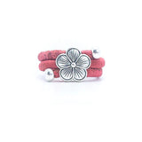 Pink cork ring with a silver vintage floral charm on a white background