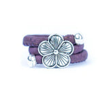 Purple cork ring with a silver vintage floral charm on a white background