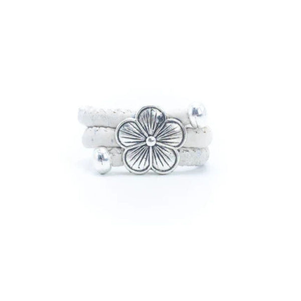 White cork ring with a silver vintage floral charm on a white background