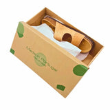 Open box with a two-strap sandal inside.