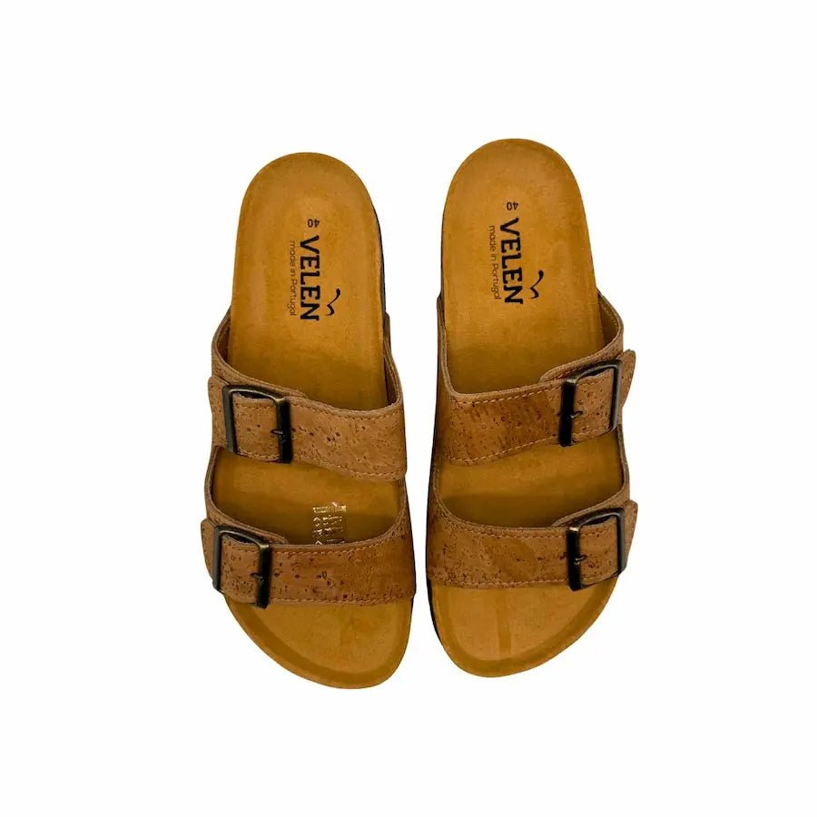 Pair of brown two-strap cork sandals with black buckles on a white background - top view