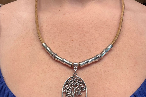 Woman wearing cork necklace with Tree of Life pendant.