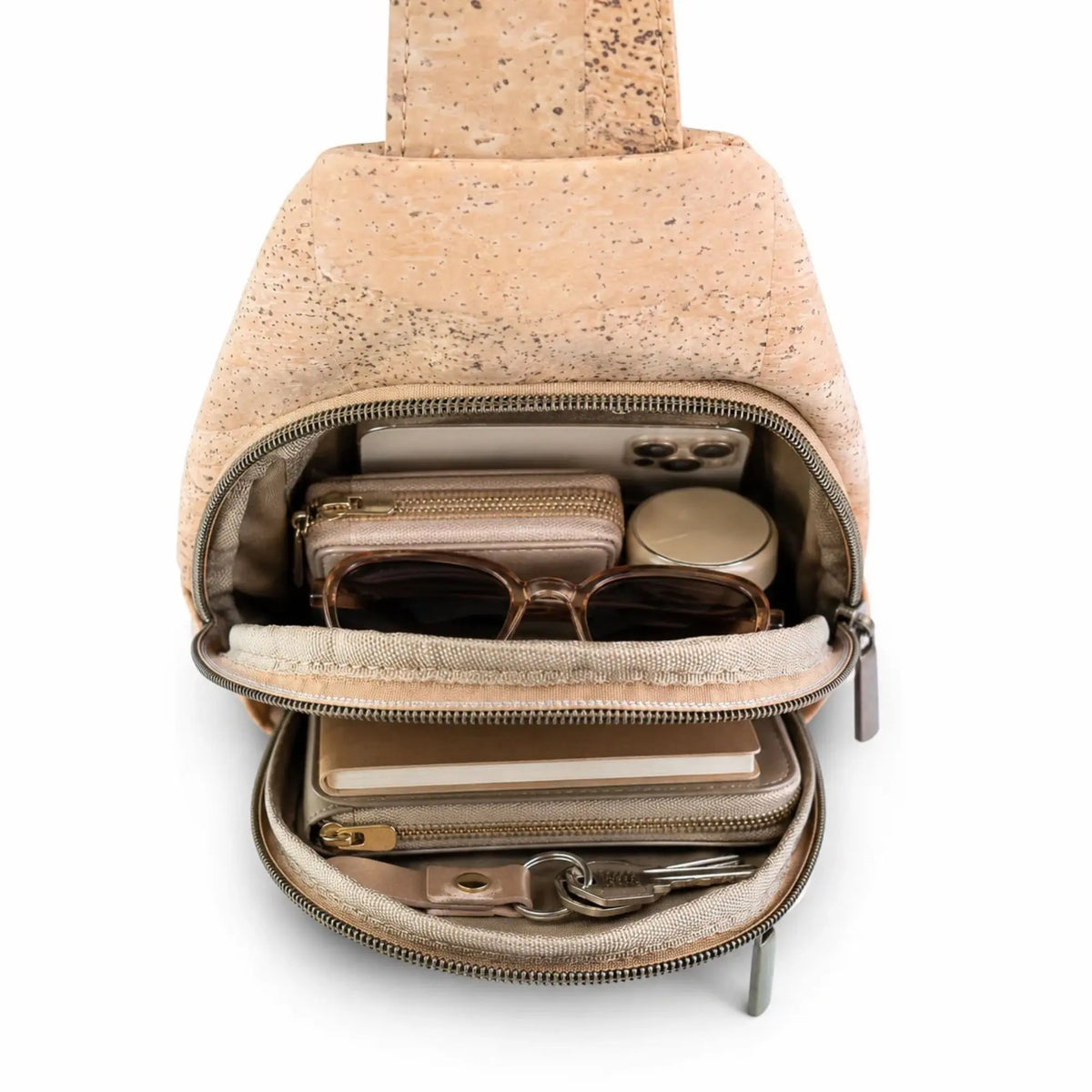 Albany Cork Sling Bag loaded with phone wallet, sunglasses, notebook, keys, zipper pouch, and makeup