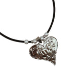 Heart-shaped silver pendant on a black cork cord with pearl-like beads
