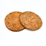 Stack of chunky cork coasters with top one offset by Texas Cork Company