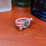 Pink colored cork ring with chrysanthemum on  a desk from Texas Cork Company
