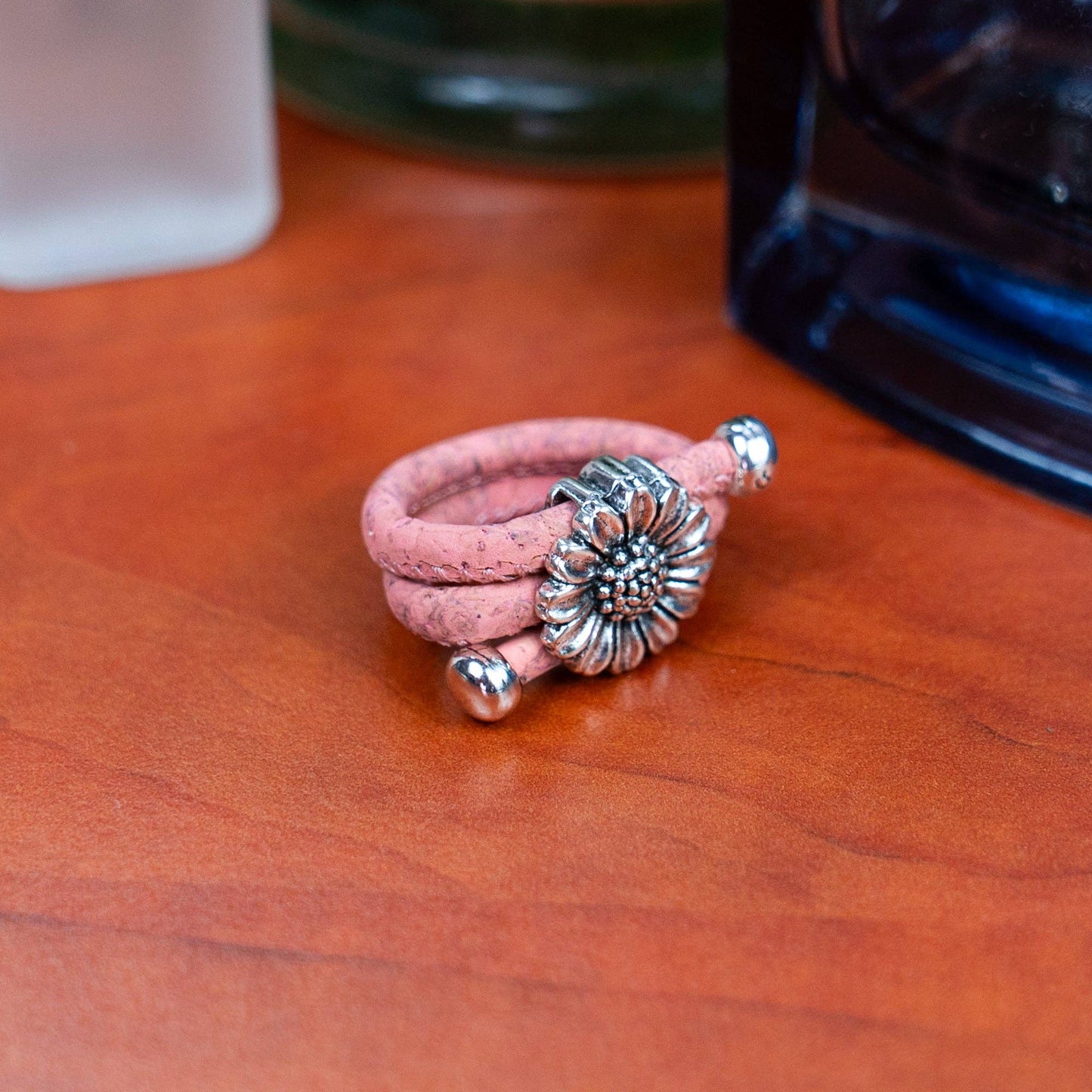Pink colored cork ring with chrysanthemum on  a desk from Texas Cork Company