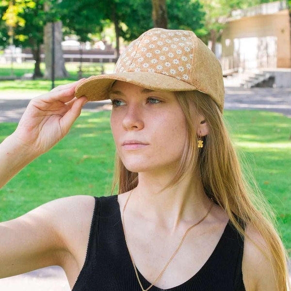 Woman wearing the Daisy print of Aggregate Cork Baseball Hat from Texas Cork Company