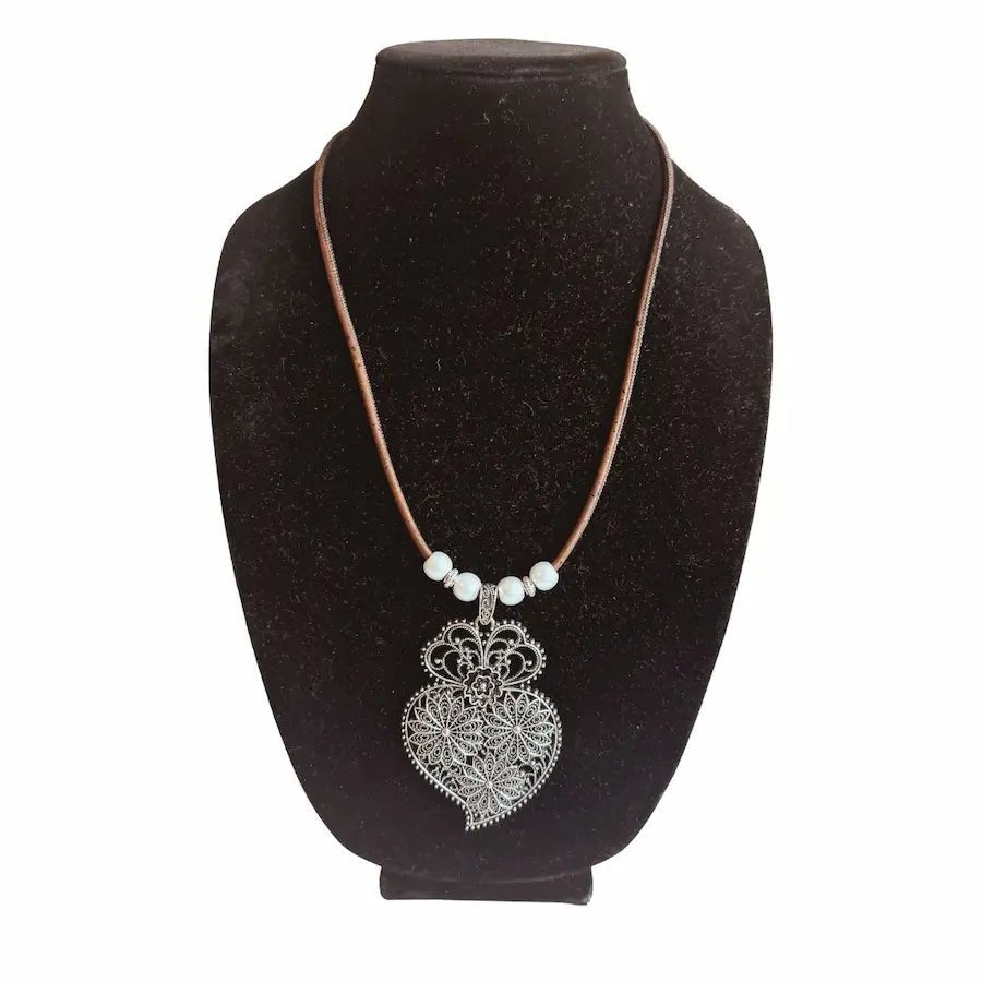 Handmade cork necklace displayed on jewelry bust, made in Texas