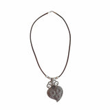 Handcrafted cork necklace with antique floral pendant on white background