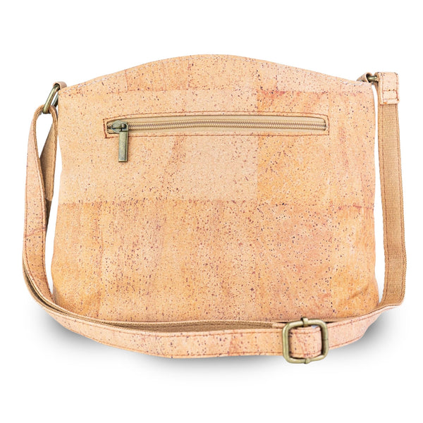 Arlington cork crossbody bag back view in a natural light tan cork texture with a zippered pocket and a gold-tone buckle, shown on a white background.