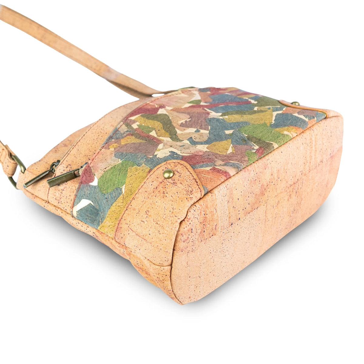 Arlington cork crossbody bag bottom view - made from natural cork, featuring a multicolor abstract patterned top panel and a light tan strap, shown on a white background.