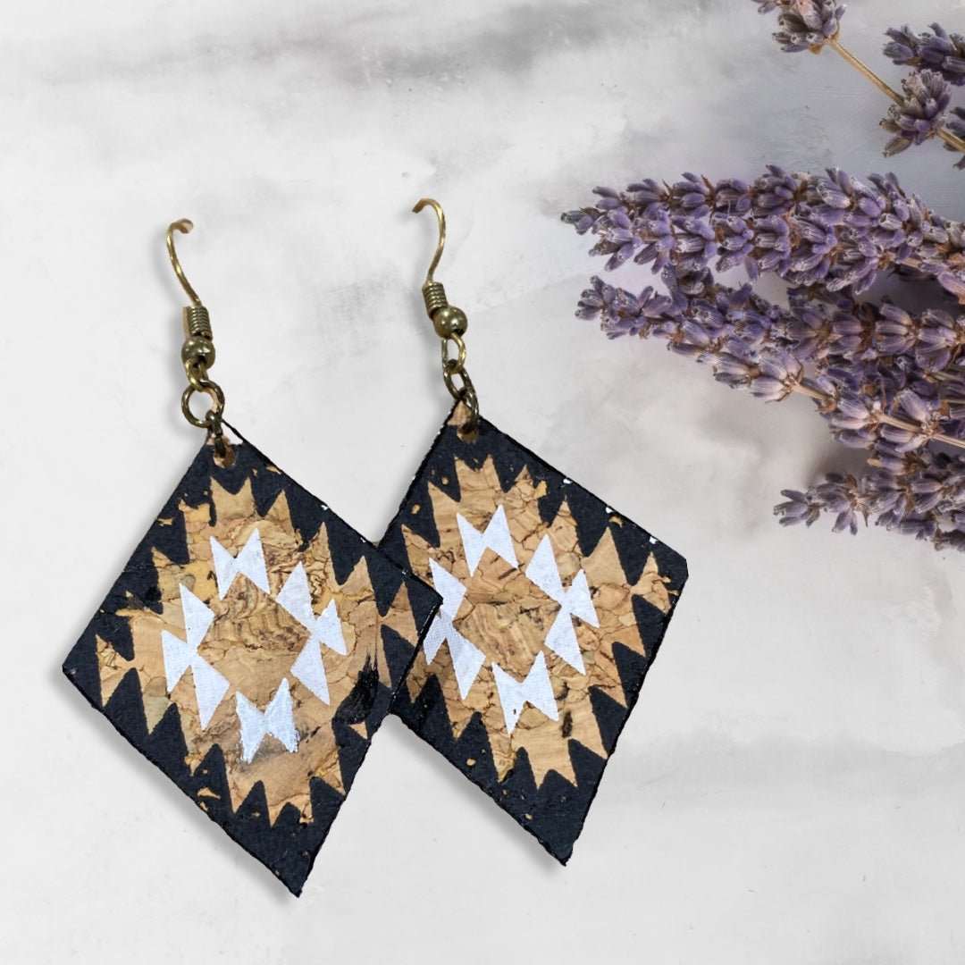 Front view natural, white, and black Aztec Inspired Cork Leather Earrings with lavendar leaves in background -Texas Cork Company