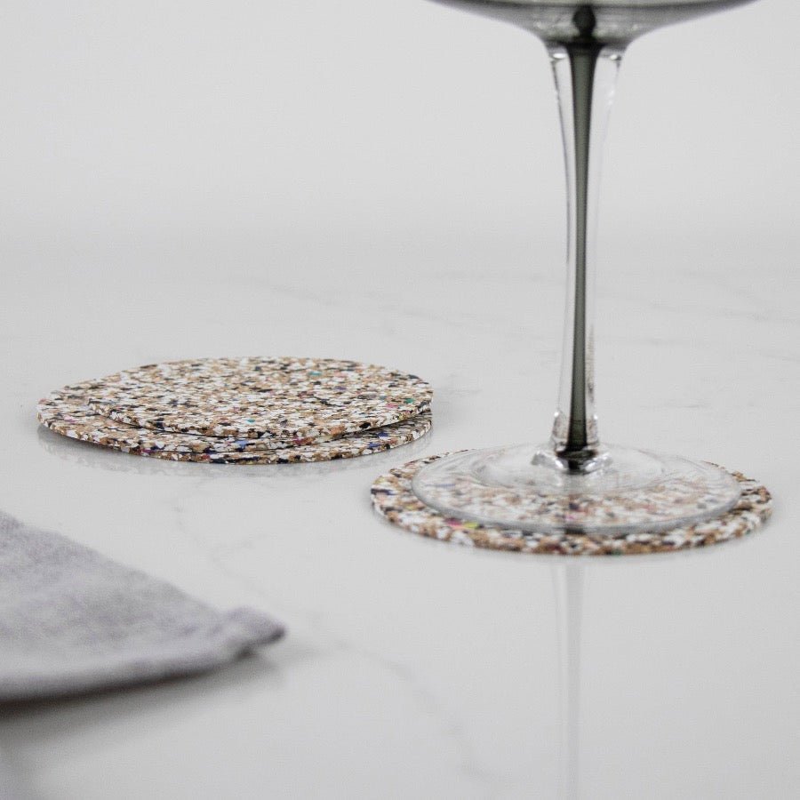 Round Beach Clean Coasters in use with stemmed glass from Texas Cork Company