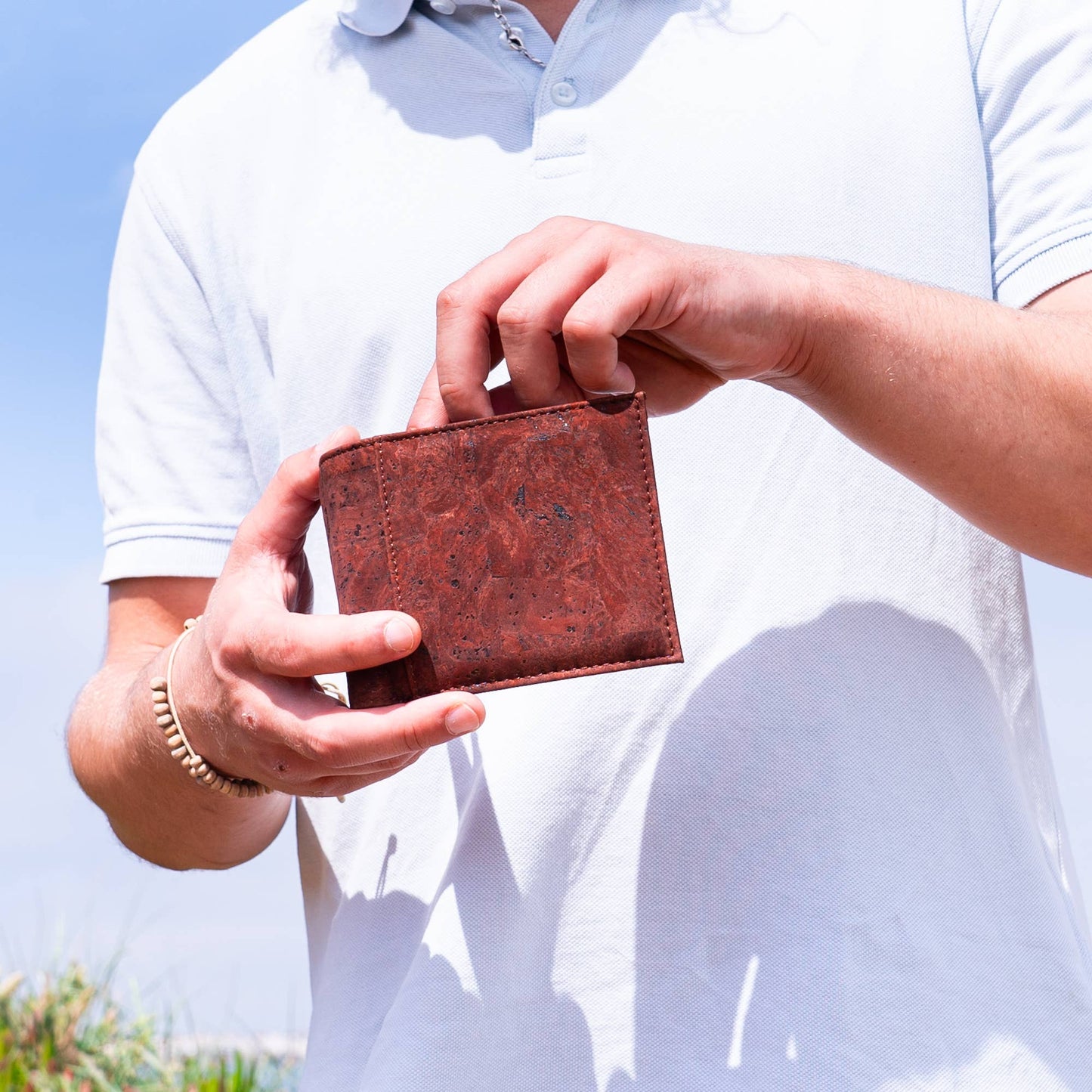 Man accessing his bifold rfid cork wallet from Texas Cork Company