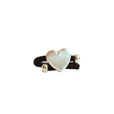 Heart-shaped silver with black cork cord ring on a white background