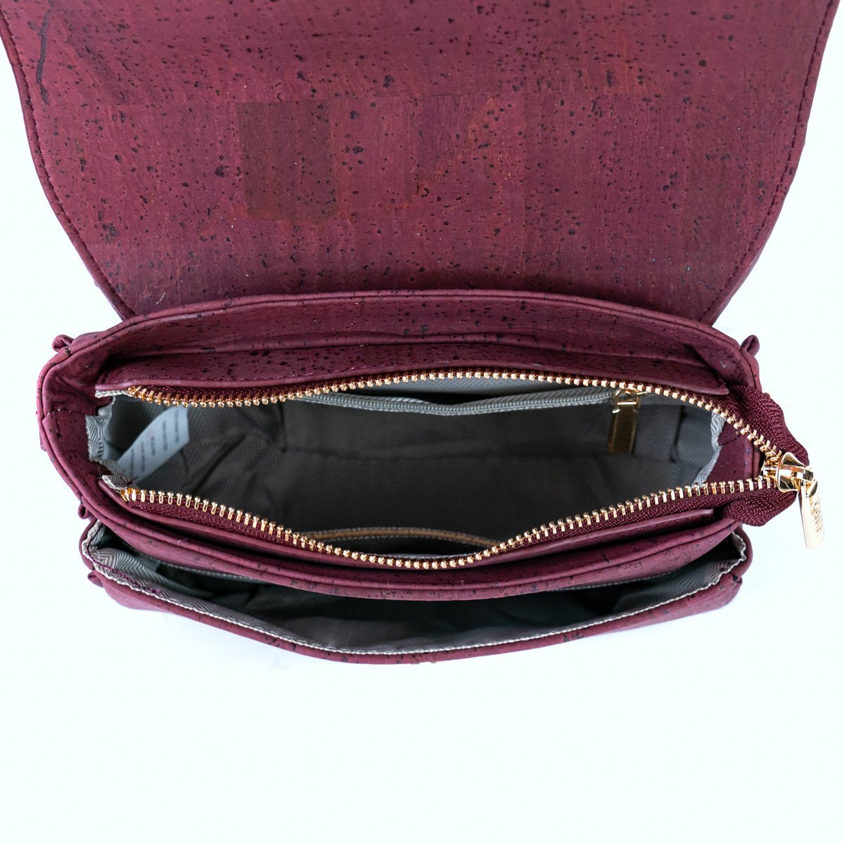 Brooklyn black cork crossbody with flap open showing front and main compartments