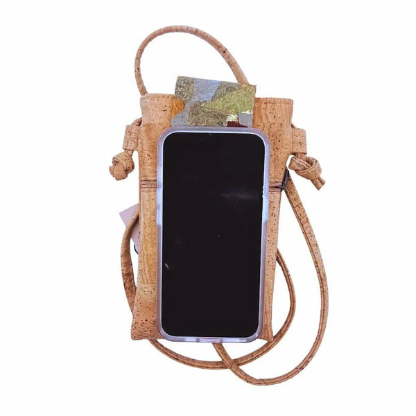 Cork cell phone case with phone on top to demonstrate size