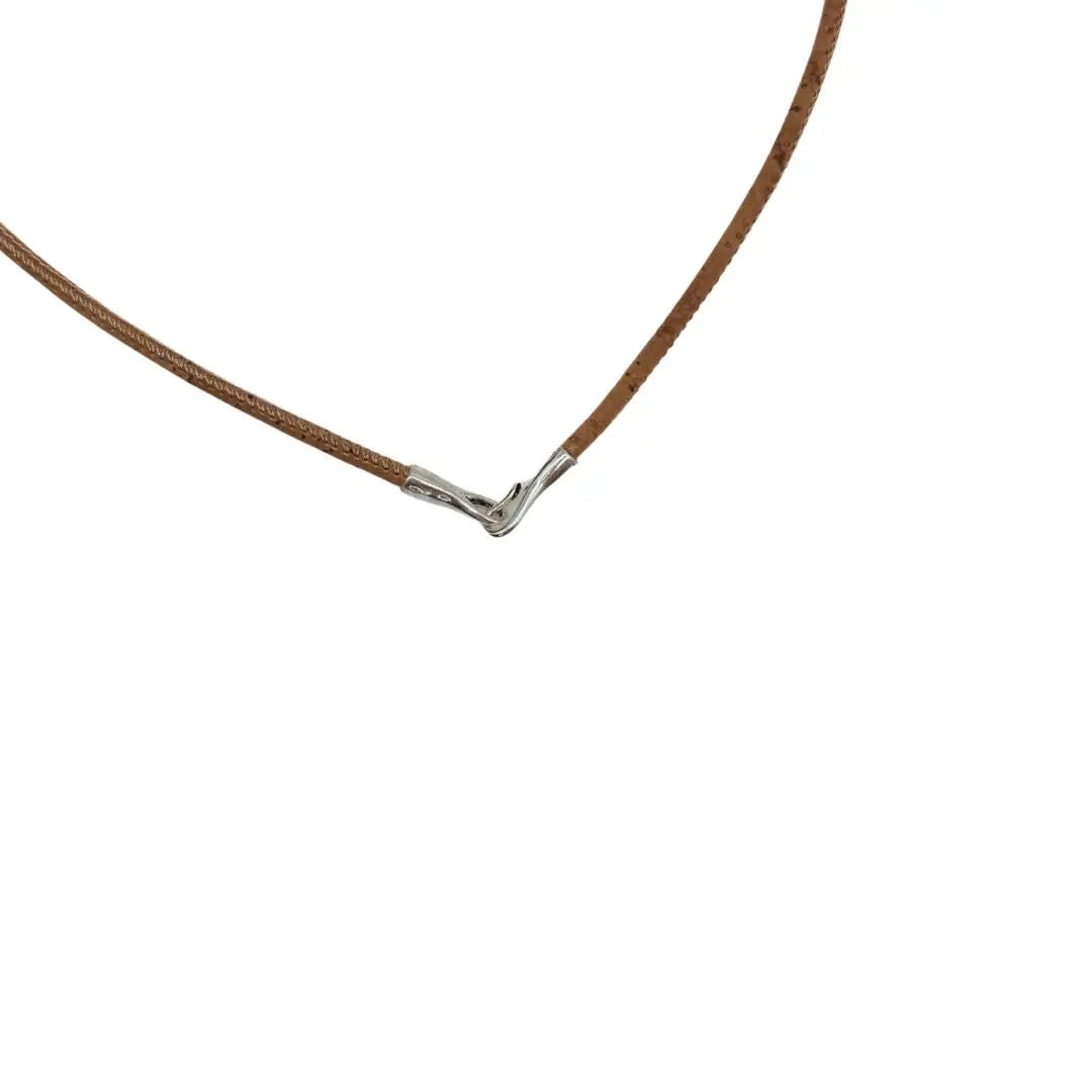 Closeup of necklace clasp on natural cork cord