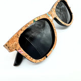 Closeup of stained cork and bamboo sunglasses with black lenses and confetti cork by Texas Cork Company.