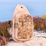 Light coffee cork chest sling travel bag from Texas Cork Company on a beach.