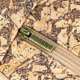 Closeup of cork and zipper on coffee cork chest sling travel bag from Texas Cork Company