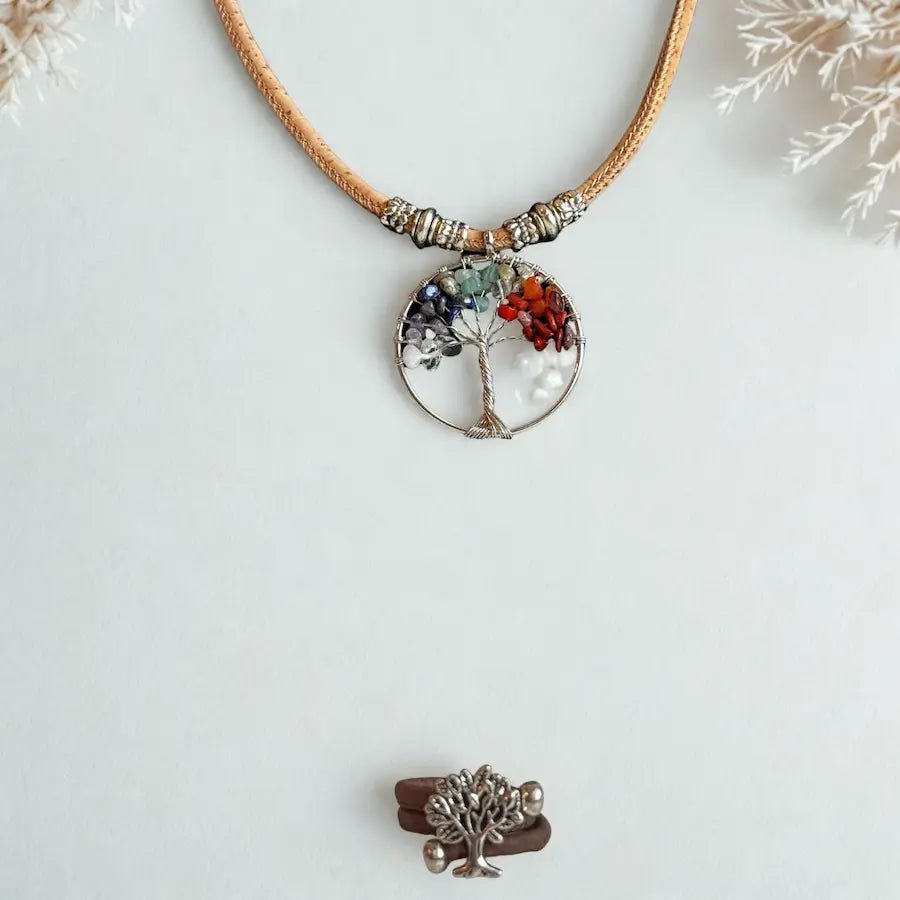Necklace with a tree of life pendant on a snowy background with brown cork ring