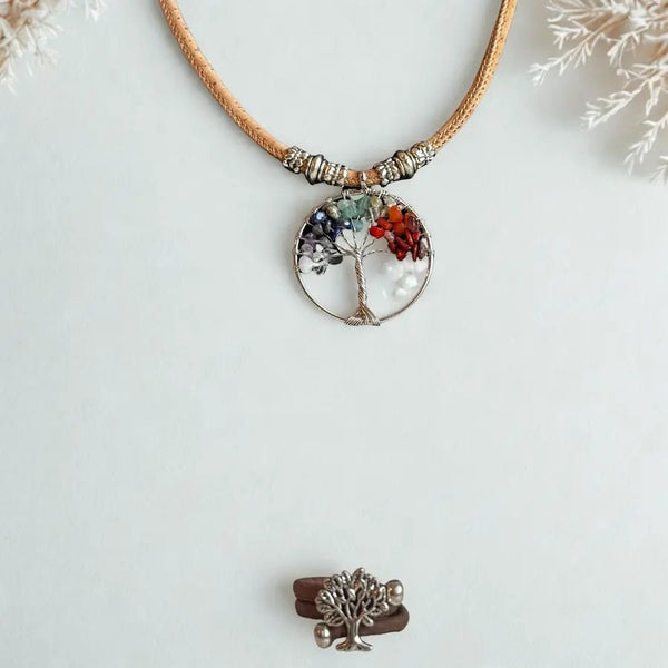 Necklace with a tree of life pendant on a snowy background with brown cork ring