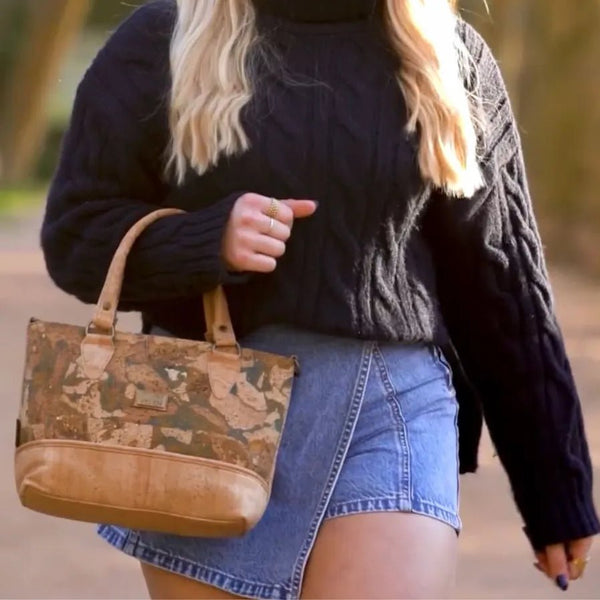 Woman walking with Convertible Handbag in Napa Luxe style and Ocean color.