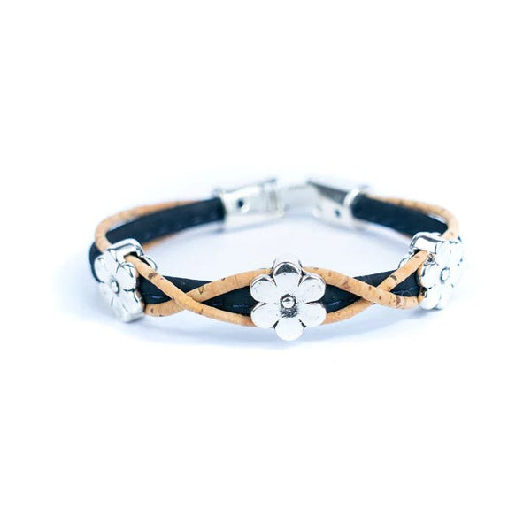 Bracelet with black and natural cork design and silver daisy charms on a white background