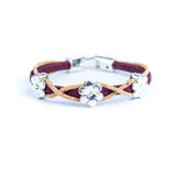 Bracelet with burgundy and natural cork design and silver daisy charms on a white background