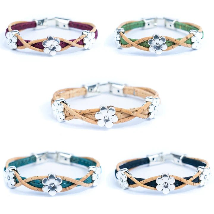 Set of five cork bracelets with daisy charms on a white background