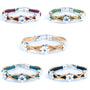 Set of five cork bracelets with daisy charms on a white background