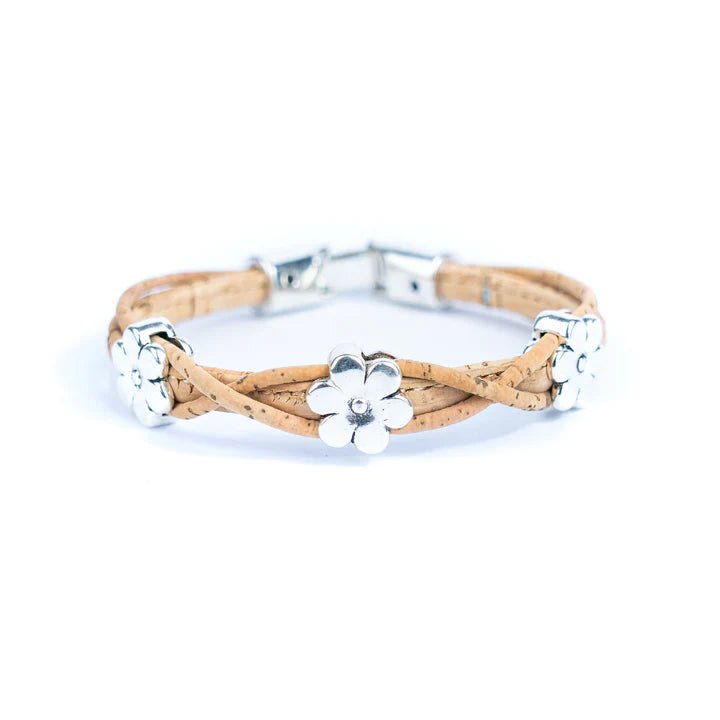 Bracelet with natural cork design and silver daisy charms on a white background
