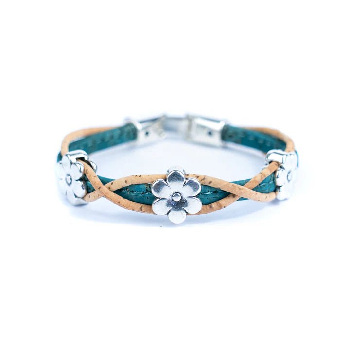 Bracelet with teal and natural cork design and silver daisy charms on a white background