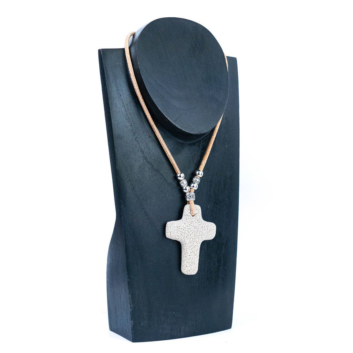 Volcanic stone cross on handmade cork necklace on a display from Texas Cork Company