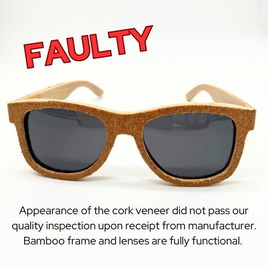 Front view of aggregate cork and bamboo sunglasses with black polarized lenses. Cork has jagged edges-faulty.