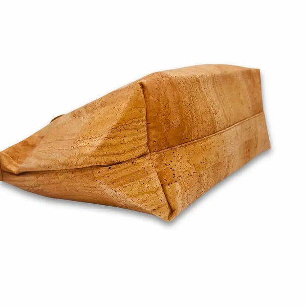 Angled view of cork tote base and side profile to show depth and reinforced corners
