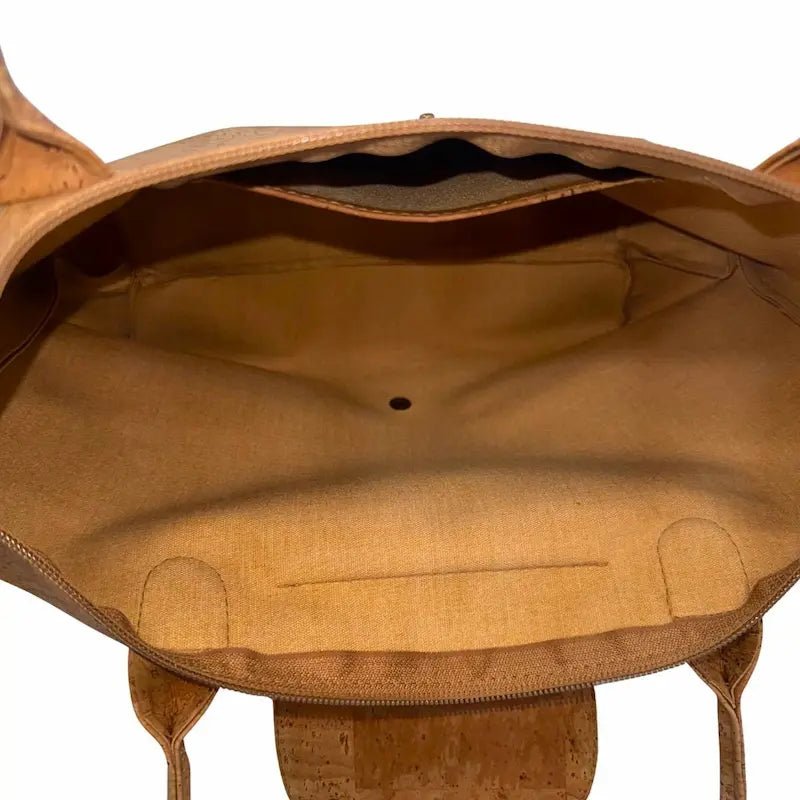 Interior of cork tote showing slip pocket and snap closure for secure storage