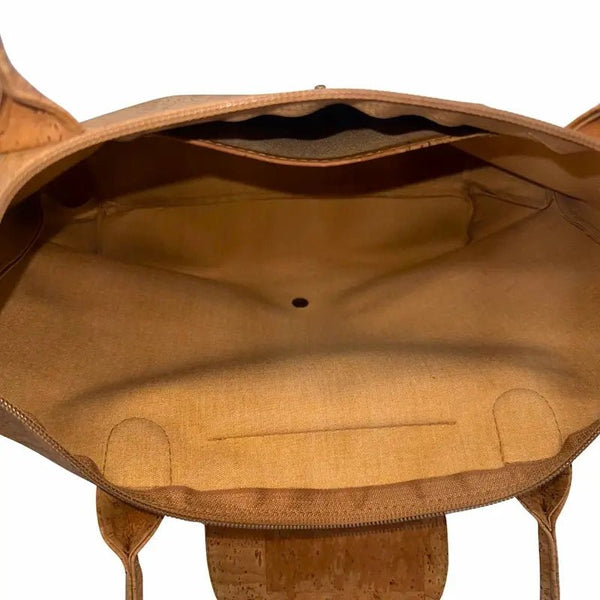 Interior of cork tote showing slip pocket and snap closure for secure storage