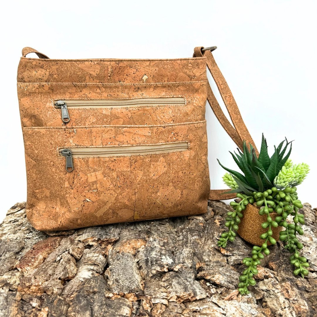 Front view of Molten Tobacco Cork Crossbody with Large Slip Pocket on bark from Texas Cork Company