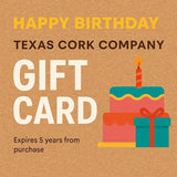 Gift Card for Birthday with cake and wrapped gift on cork background.