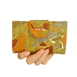 Front view Golden Gate Trifold Cork Wallet in Patchwork in woman's hand