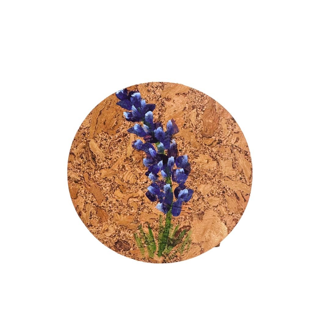 Round cork coaster with handpainted bluebonnet flower on a white background