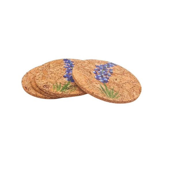 Set of four cork coasters with hand painted bluebonnet design on a white background