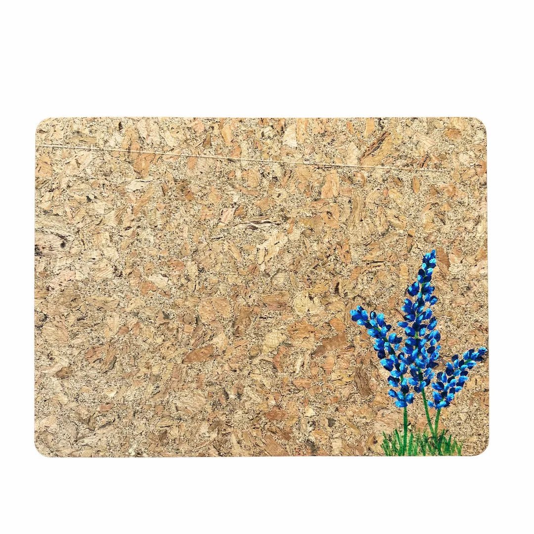 Cork placemat with handpainted bluebonnets on a white background