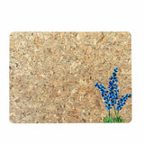 Cork placemat with handpainted bluebonnets on a white background